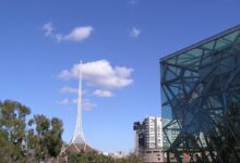 The Arts Centre Melbourne spire rising above the Theatres Building on Southbank, with the rooftop sculpture and stage tower visible.