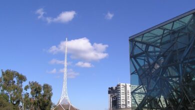 The Arts Centre Melbourne spire rising above the Theatres Building on Southbank, with the rooftop sculpture and stage tower visible.