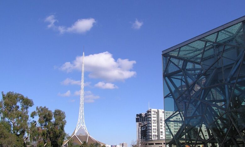 The Arts Centre Melbourne spire rising above the Theatres Building on Southbank, with the rooftop sculpture and stage tower visible.